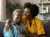 Caregiver assisting senior woman at home