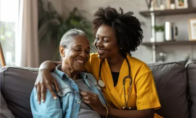 Caregiver assisting senior woman at home