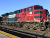 Ferromex locomotive working a train in the United States against a blue sky with no people