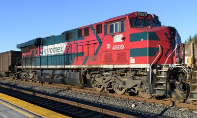Ferromex locomotive working a train in the United States against a blue sky with no people