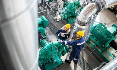 Refinery workers or engineers inspecting gas pipes