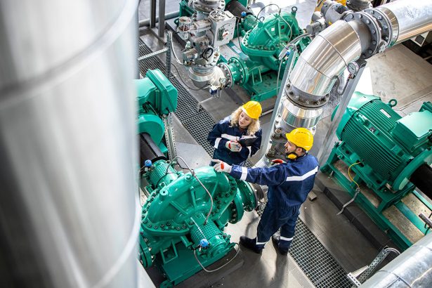 Refinery workers or engineers inspecting gas pipes