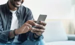 Young man using mobile phone.